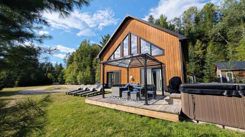 Deck, sectional, dining table, lounge chairs, hot tub, gazebo