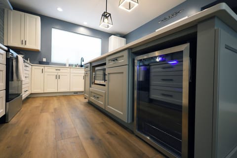 Beverage fridge and microwave located within the 8 foot island.