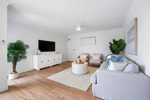 Relax in the stylish and light-filled living room, complete with smart TV, cozy seating, and coastal-inspired décor.