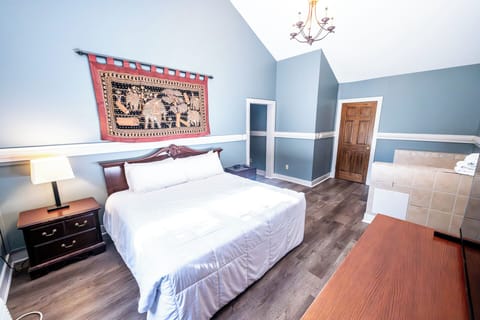 Sleep soundly in a serene bedroom with high ceilings.