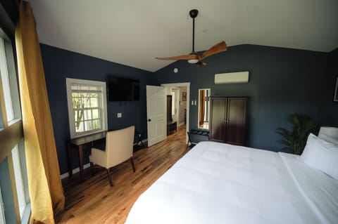 Kick back in a stylish room with desk and wall TV.