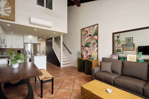 Spacious living room, kitchen, and stairs that lead to upstairs bedrooms