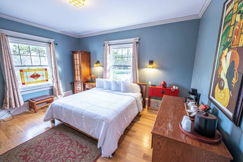 Relax into plush pillows beside warm, inviting bedside sconces.