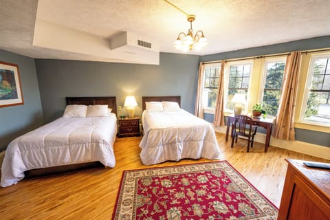 Relax in a spacious room with twin beds and soft lighting.