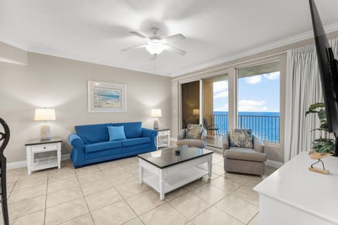 Relax in this bright living room with ocean views through large windows.