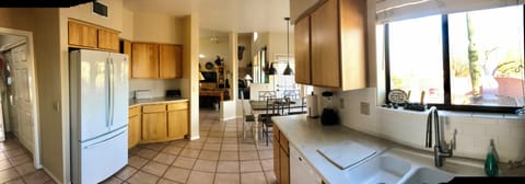 Panorama view from over area. Garage & laundry on left side, backyard on Right