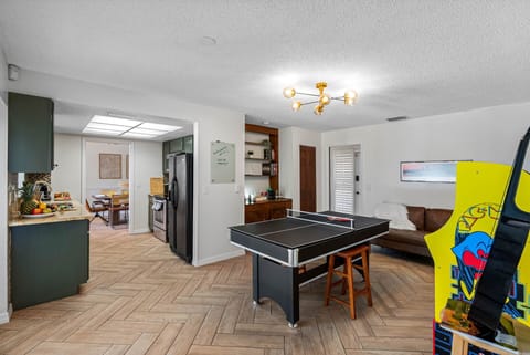Whether you're into casual lounging or full-on battles, this game room has you covered. Enjoy a round of table tennis, perfect your aim with darts, or go for a high score on the Pac-Man arcade.