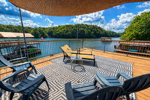 Sun-soaked lakeside deck with panoramic water views—your front-row seat to relaxation.