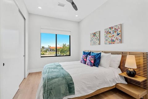 Wake up to natural light and exterior views, featuring a queen-size bed.

