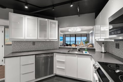 Updated, Fully Equipped Kitchen with Sleek White Cabinets and Stainless-Steel Appliances