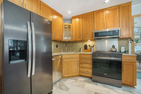 Stainless appliances for you to use and cabinets and drawers with supplies for your convenience.