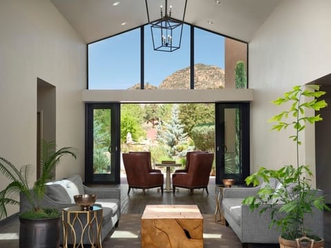 Relax in a sunlit lounge framed by stunning mountain views.