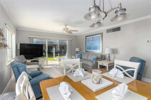 Enjoy open, beach-inspired living with a cozy seating area, dining for six, and sliding doors leading to pool and ocean views—perfect for a relaxing seaside stay.