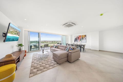 Settle into your open-plan living space, where plush seating, contemporary art, and expansive balcony views create the perfect retreat for relaxation and dining.