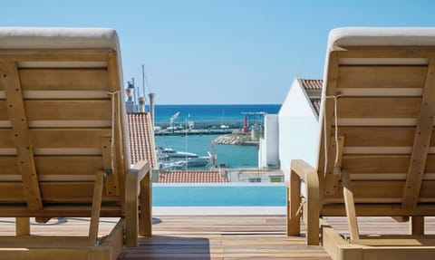 Seasonal outdoor pool, open 10:00 AM to 8:30 PM, pool umbrellas
