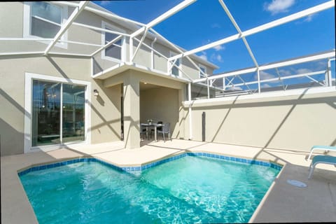 Refresh in your private screened pool oasis, complete with turquoise waters, a covered dining nook for al fresco meals, and sunny loungers-modern comfort meets shady retreat in this stylish backyard escape!