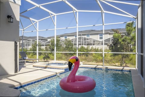 Make a splash in your private, screened pool oasis-complete with a vibrant flamingo float and plenty of space to soak up the sun!