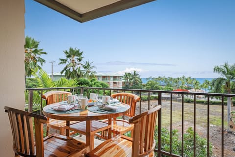 Savor ocean breezes and island views from your private lanai - Start your morning or unwind at sunset on the lanai, with a beautifully set table and panoramic views of the Pacific, swaying palms, and lush tropical greenery