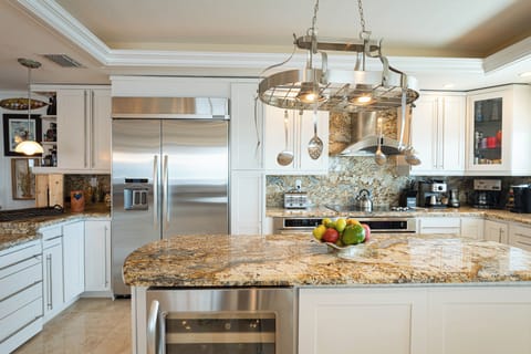 Prepare meals on granite countertops with stainless steel appliances and style.