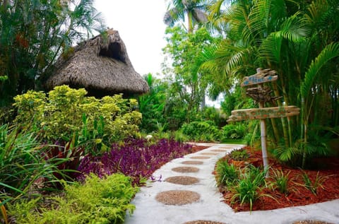 Garden path with plants, flowers, and stone walkway leading ahead