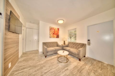 Seating area with sofa, chair, table, and carpet flooring