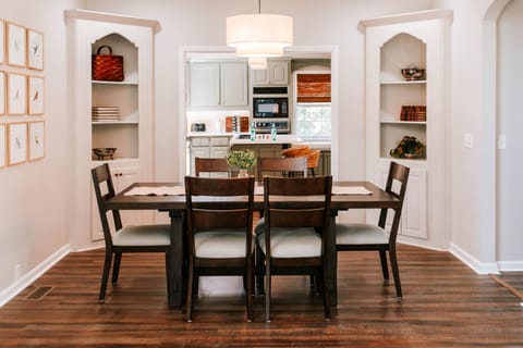 Gather 'round and make memories! ✨ This warm and inviting dining space is perfect for shared meals, game nights, or morning coffee chats—just steps from a full-equipped kitchen!