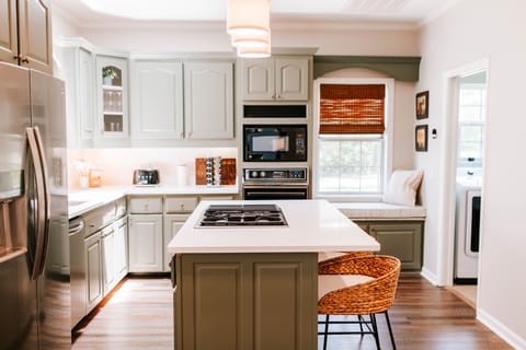Whether you're whipping up a home-cooked meal or sipping your morning coffee at the island, this kitchen is fully stocked and ready for you. Bonus: that cozy window seat is perfect for lounging with a cookbook or catching the morning sun.