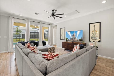 This luxury vacation home features a bright living area with a comfotable sofa, and leads to your lovely private pool.