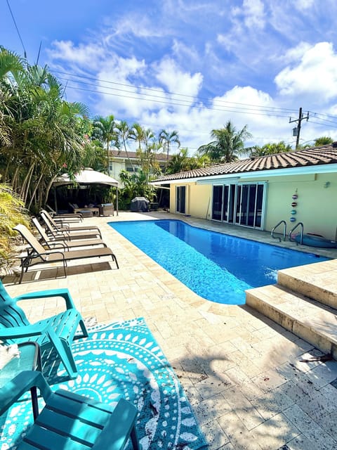 Pool area with lots of loungers, BBQ and Canopy