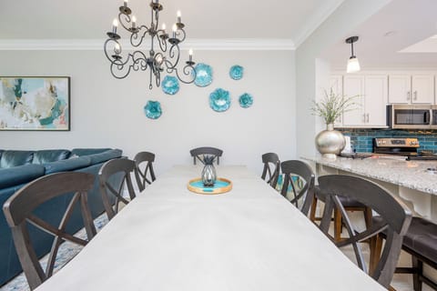 Pull up a chair at the long dining table under the iron chandelier and create memorable moments