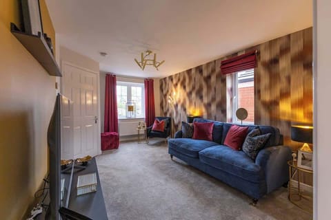 "Cozy and stylish living room with modern décor, vibrant accents, and a warm atmosphere — perfect for relaxing or entertaining with family and friends."