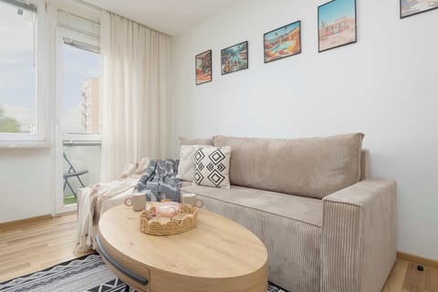 A welcoming living space with a comfortable sofa, coffee table, and soft lighting.