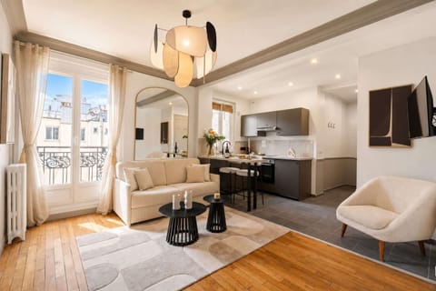 The living room features a sofa, HD flat-screen TV, and free high-speed Wi-Fi.