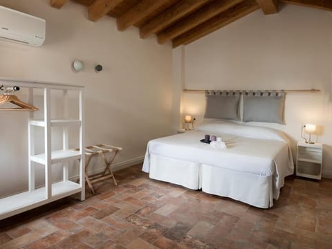 Family Triple Room, Courtyard View | Blackout drapes, iron/ironing board, free WiFi