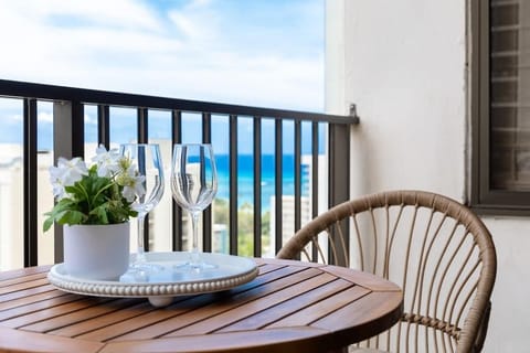 Enjoy breathtaking partial ocean views while having your refreshing drink from this inviting balcony, featuring a charming table with 2 chairs.