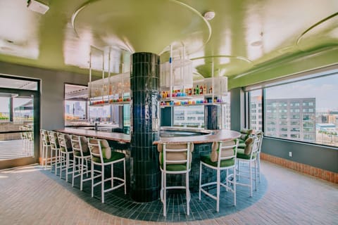 Stylish rooftop bar with high chairs and full skyline backdrop