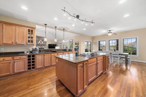 Spacious Kitchen is well equipped for cooking for large gatherings.  Kitchen opens onto Great Room, and Dining Area table with 8 chairs.