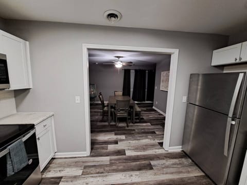 The kitchen is connected to the dining room area.