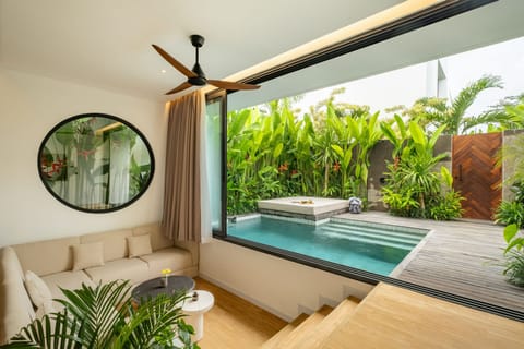 Deluxe Villa, 2 Bedrooms, Patio, Pool View | Living room | 65-inch TV with cable channels