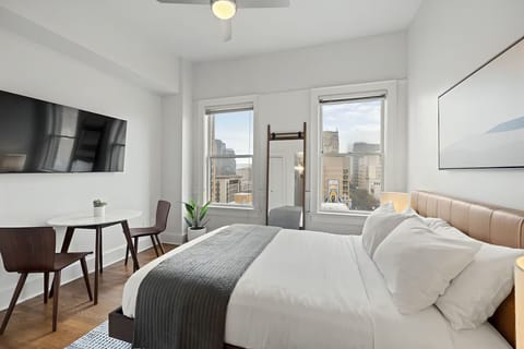 Stretch out in bed and enjoy skyline views and TV.