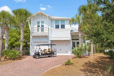 Street view showing the second floor balcony above the garage and the covered front porch.