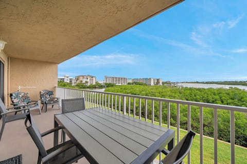Enjoy outdoor dining on the spacious balcony overlooking lush greenery & open skies.