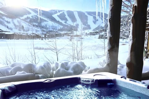 Soak in your private hot tub with sweeping views of the snowy slopes, just the spot for après-ski recovery or morning coffee.