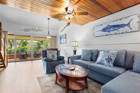 Sink into plush seating under warm wood ceilings and let tropical breezes drift in from your private balcony overlooking swaying palms.