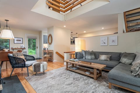 - Spacious living room with modern sofa seating   - Open layout connects to dining and kitchen   - Comfortable lounge area for group gatherings