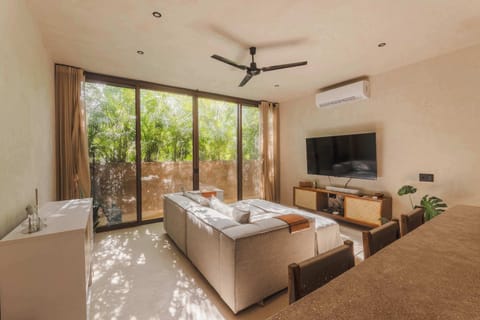 Spacious and bright living room with Smart TV, comfortable seating.
