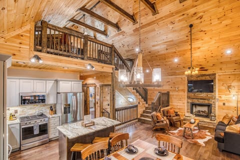 Our modern rustic living room offers comfort and style. Relax by the cozy gas fireplace or watch the Smart TV. This inviting space flows seamlessly into the open kitchen and dining.