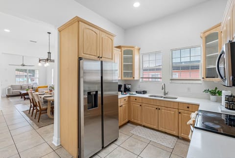 This well-lit kitchen includes stainless steel appliances, ample storage, and a functional design for everyday use.