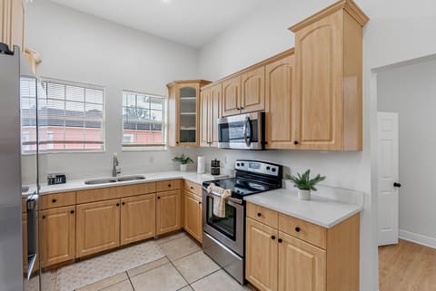 The kitchen offers a warm and inviting atmosphere with modern features and plenty of room to prepare meals.