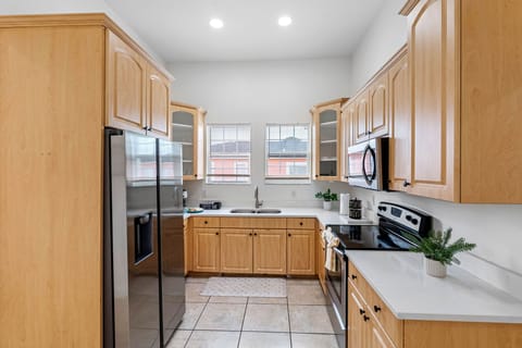 The kitchen is equipped with modern appliances, clean finishes, and generous counter space for a comfortable cooking experience.